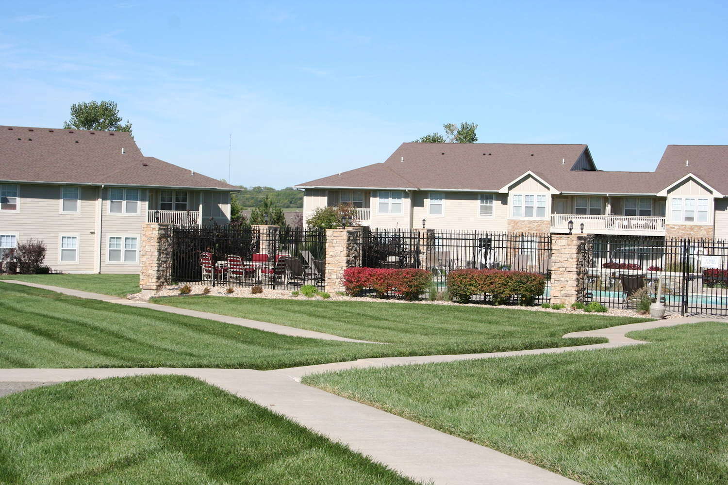 Landscaped grounds of Ironwood Court Apartments with swimming pool